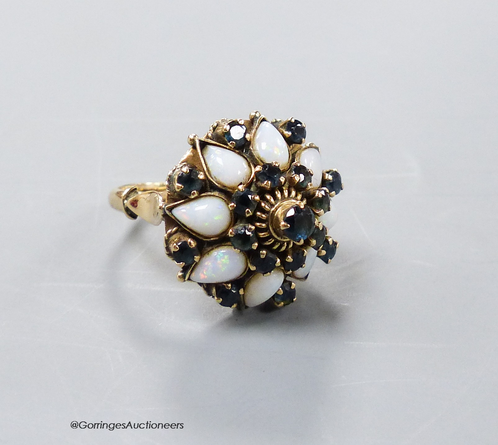 A yellow metal (stamped 18k), white opal and sapphire cluster set 'hareem' ring, size O, gross 6.6 grams.